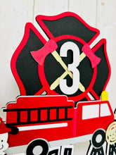 Load image into Gallery viewer, firefighter firetruck cake topper featuring fireman emblem, fire truck, fire hose, flame, fire hydrant, dalmatian and fire extinguisher