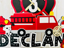 Load image into Gallery viewer, firefighter firetruck cake topper featuring fireman emblem, fire truck, fire hose, flame, fire hydrant, dalmatian and fire extinguisher