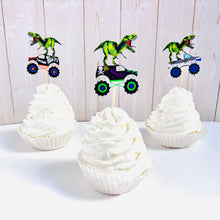 Load image into Gallery viewer, Monster jam inspired monster trucks with a T-Rex dinosaur cupcake toppers. Each monster truck features a T-Rex standing on the back of the truck. The monster truck dinosaur cupcake toppers are professionally printed, cut and attached to four inch bamboo skewers. The monster truck dinosaur cupcake toppers are handcrafted in the USA. The truck options are Grave Digger, Megaladon, El Toro Loco, Tornado and Dragon.