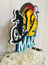 Load image into Gallery viewer, Mountain bike cake topper featuring MTB bike and rider, full face helmet, name, age, bicycle tire and wheel spokes