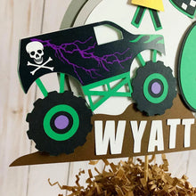 Load image into Gallery viewer, Monster Jam inspired monster truck cake topper. The cake topper features a monster jam inspired monster truck on a dirt mound, a checkered flag, tropy and number. The cake topper is also personalizable with your child's name. The truck options are Grave Digger, Megaladon, El Toro Loco, Tornado and Dragon.