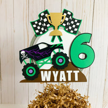 Load image into Gallery viewer, Monster Jam inspired monster truck cake topper. The cake topper features a monster jam inspired monster truck on a dirt mound, a checkered flag, tropy and number. The cake topper is also personalizable with your child's name. The truck options are Grave Digger, Megaladon, El Toro Loco, Tornado and Dragon.