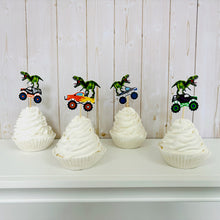 Load image into Gallery viewer, Monster jam inspired monster trucks with a T-Rex dinosaur cupcake toppers. Each monster truck features a T-Rex standing on the back of the truck. The monster truck dinosaur cupcake toppers are professionally printed, cut and attached to four inch bamboo skewers. The monster truck dinosaur cupcake toppers are handcrafted in the USA. The truck options are Grave Digger, Megaladon, El Toro Loco, Tornado and Dragon.
