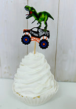 Load image into Gallery viewer, Monster jam inspired monster trucks with a T-Rex dinosaur cupcake toppers. Each monster truck features a T-Rex standing on the back of the truck. The monster truck dinosaur cupcake toppers are professionally printed, cut and attached to four inch bamboo skewers. The monster truck dinosaur cupcake toppers are handcrafted in the USA. The truck options are Grave Digger, Megaladon, El Toro Loco, Tornado and Dragon.