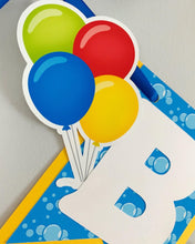 Load image into Gallery viewer, Waterslide summer happy birthday banner featuring fun summer elements that include ice cream, water guns, water balloons, umbrellas, sunglasses, beach chairs, beach balls and a waterslide.