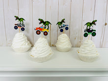 Load image into Gallery viewer, Monster jam inspired monster trucks with a T-Rex dinosaur cupcake toppers. Each monster truck features a T-Rex standing on the back of the truck. The monster truck dinosaur cupcake toppers are professionally printed, cut and attached to four inch bamboo skewers. The monster truck dinosaur cupcake toppers are handcrafted in the USA. The truck options are Grave Digger, Megaladon, El Toro Loco, Tornado and Dragon.