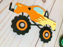 Load image into Gallery viewer, Monster Jam inspired monster truck cutouts handcrafted by Declan & Smith Party Decor. The trucks are cut from cardstock and assembled by hand. The truck cutouts are avaiable with or without the skewer and can be used in a variety of ways for your monster jam monster truck party.
