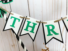 Load image into Gallery viewer, Monster Jam inspired monster truck cake topper bunting. The cake toppers feature two checkered flags, pennant flags that read either an age, name or word. Each cake topper includes a coordinating monster jam inspired truck.