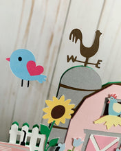 Load image into Gallery viewer, The pink barnyard farm animals cake topper features a pink barn, pink tractor, white picket fence, farm animals and a pink and light blue pennant banner to display your little one's name.