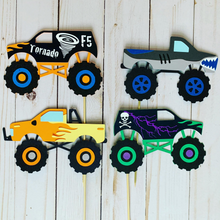 Load image into Gallery viewer, Monster Jam inspired monster truck cutouts handcrafted by Declan & Smith Party Decor. The trucks are cut from cardstock and assembled by hand. The truck cutouts are avaiable with or without the skewer and can be used in a variety of ways for your monster jam monster truck party.