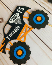 Load image into Gallery viewer, Monster Jam inspired monster truck cutouts handcrafted by Declan & Smith Party Decor. The trucks are cut from cardstock and assembled by hand. The truck cutouts are avaiable with or without the skewer and can be used in a variety of ways for your monster jam monster truck party.