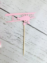 Load image into Gallery viewer, pink airplane centerpiece with a pink airplane, pink and blue pinwheel and white cloud with a blue number one
