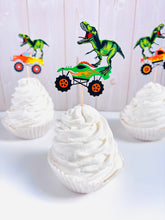 Load image into Gallery viewer, Monster jam inspired monster trucks with a T-Rex dinosaur cupcake toppers. Each monster truck features a T-Rex standing on the back of the truck. The monster truck dinosaur cupcake toppers are professionally printed, cut and attached to four inch bamboo skewers. The monster truck dinosaur cupcake toppers are handcrafted in the USA. The truck options are Grave Digger, Megaladon, El Toro Loco, Tornado and Dragon. 
