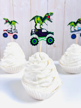 Load image into Gallery viewer, Monster jam inspired monster trucks with a T-Rex dinosaur cupcake toppers. Each monster truck features a T-Rex standing on the back of the truck. The monster truck dinosaur cupcake toppers are professionally printed, cut and attached to four inch bamboo skewers. The monster truck dinosaur cupcake toppers are handcrafted in the USA. The truck options are Grave Digger, Megaladon, El Toro Loco, Tornado and Dragon. 
