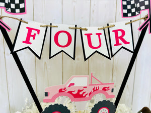 Pink monster truck cake topper. The cake topper is customizable and can display an age, name, word or phrase. The colors are also customizable. The pink monster truck cake topper features two checkered flags, pennant banner and a monster truck to display underneath the bunting. The pink monster truck cake topper is designed and handcrafted by Laura, the owner of Declan & Smith Party Decor. 