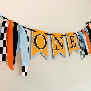 McLaren Formula One racing inspired birthday banner featuring blue orange and black and checkered flag fabric