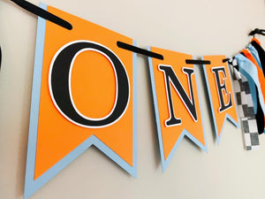 McLaren Formula One racing inspired birthday banner featuring blue orange and black and checkered flag fabric