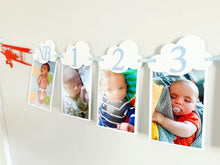 Load image into Gallery viewer, Airplane time flies birthday decorations. Vintage biplane first birthday monthly milestones photo banner featuring white clouds, number NB - 12. 
