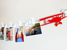 Load image into Gallery viewer, Airplane time flies birthday decorations. Vintage biplane first birthday monthly milestones photo banner featuring white clouds, number NB - 12. 
